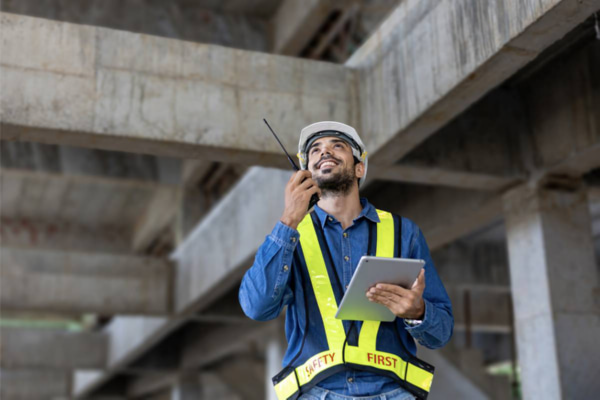 Construction Workers Using Noise Cancelling Walkie Talkies